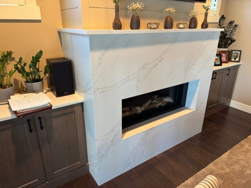 Quartz fireplace surround and mantel in a living room with built in cabinetry
