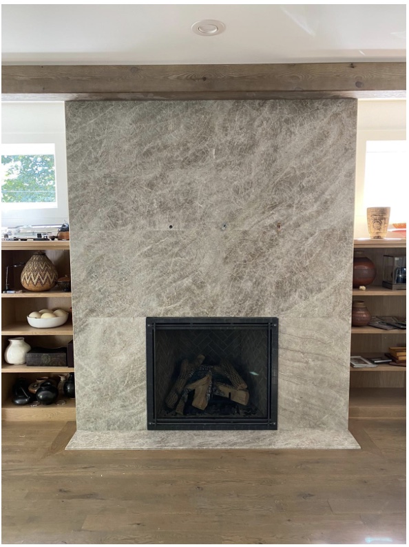 Full height natural stone slab fireplace surround with reclaimed wood mantel beam